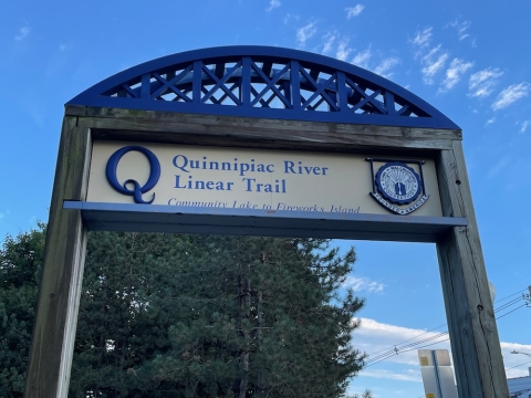 A picture of the sign for the QU trail, Community Lake Park entrance. 