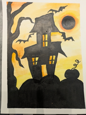 haunted house silhouette with a watercolor sunset background