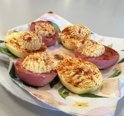 Deviled eggs with egg whites that have been dyed red and yellow.