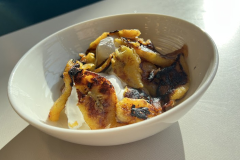 Caramelized plantains and vanilla ice cream in a bowl.