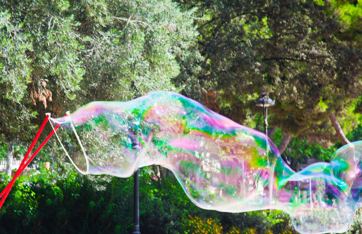 Red bubble wand with a giant bubble outside