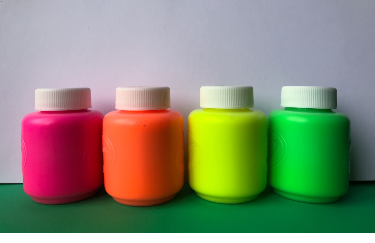 Neon paints in a jars lined up