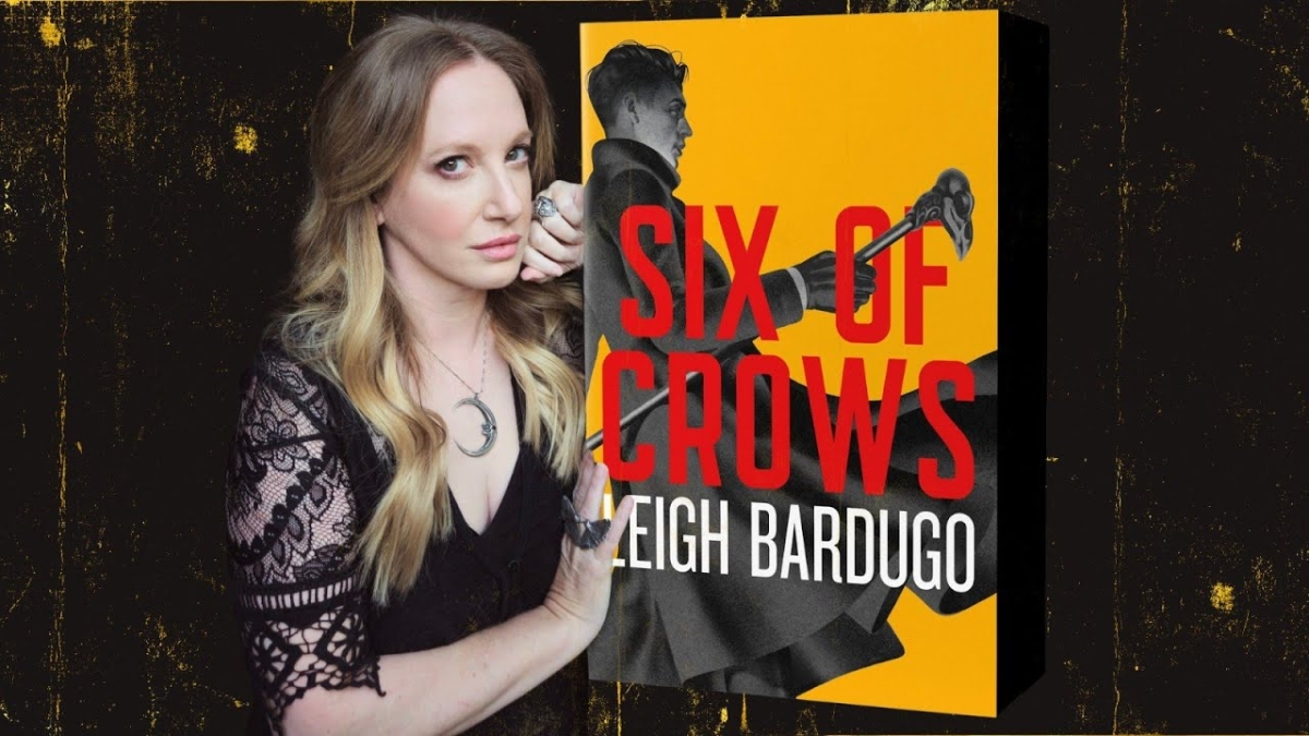 Photo of author Leigh Bardugo with 10th anniversary cover of her novel Six of Crows